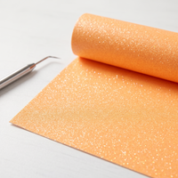 Roll of neon orange glitter heat transfer vinyl